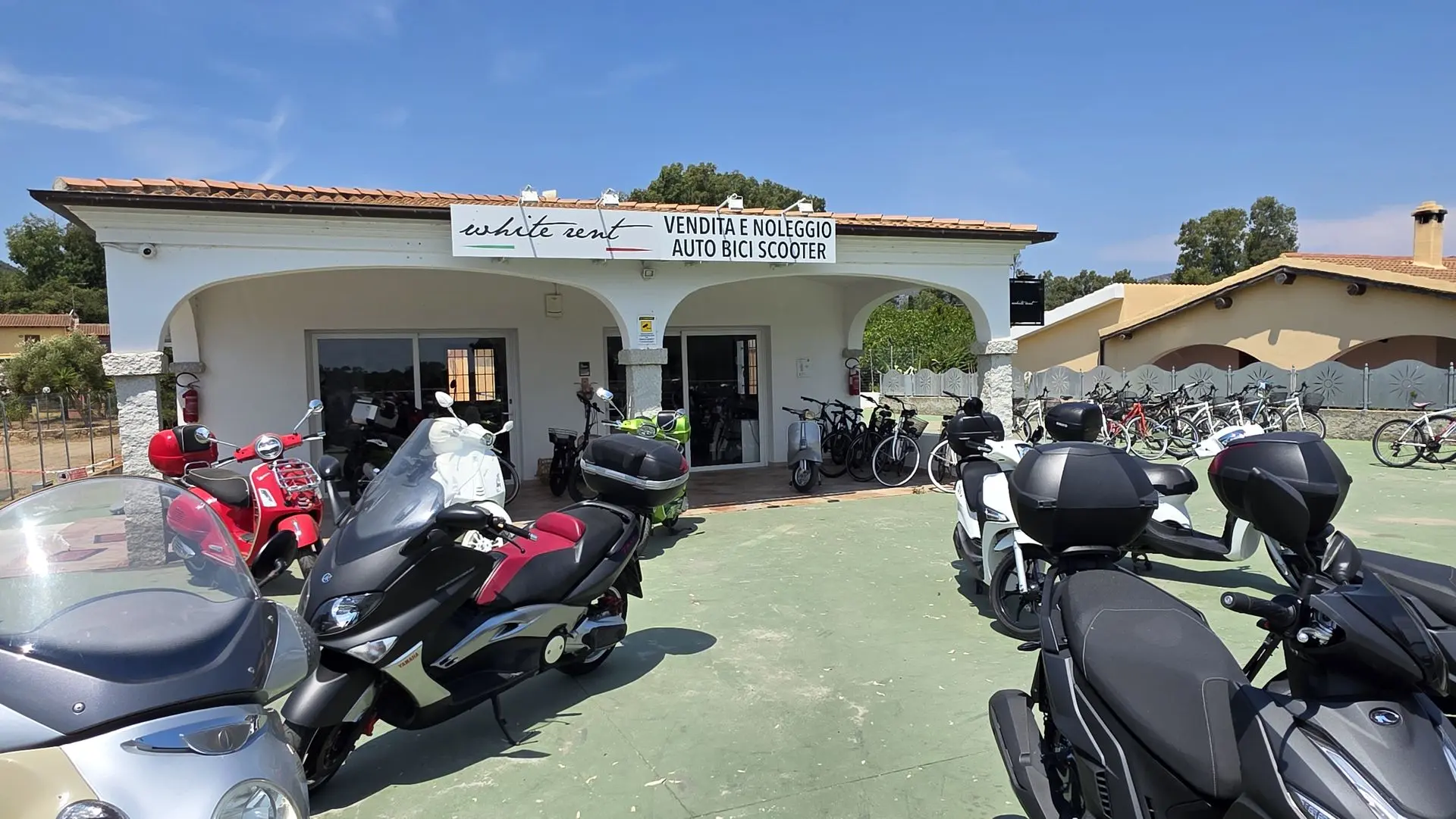 White Rent car, scooter and bicycle rental office near San Teodoro