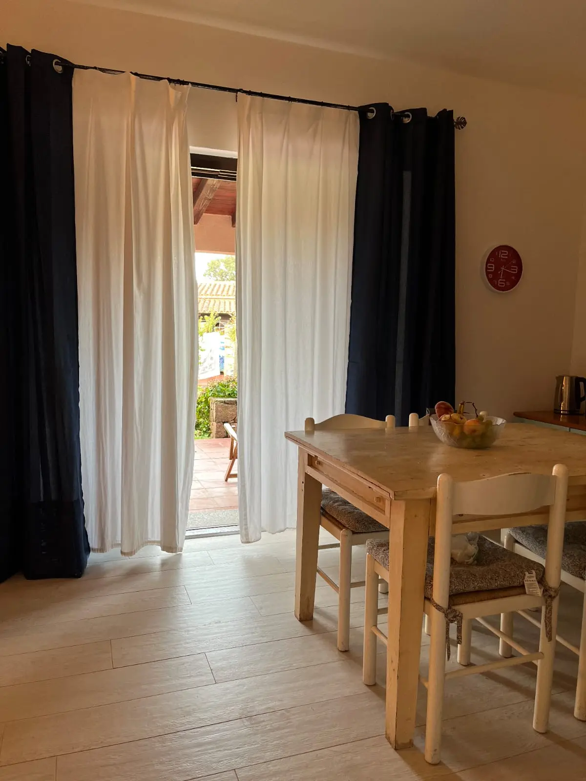 Indoor dining table beside the open doorway to the garden terrace