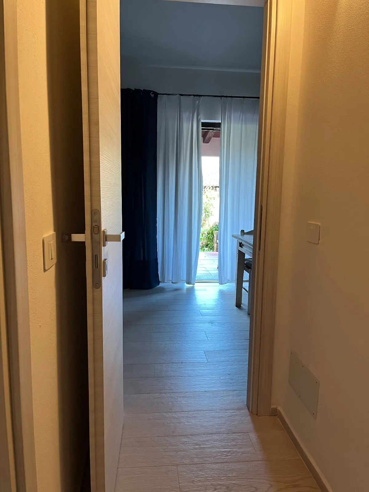 Bright hallway leading toward the villa living and dining area