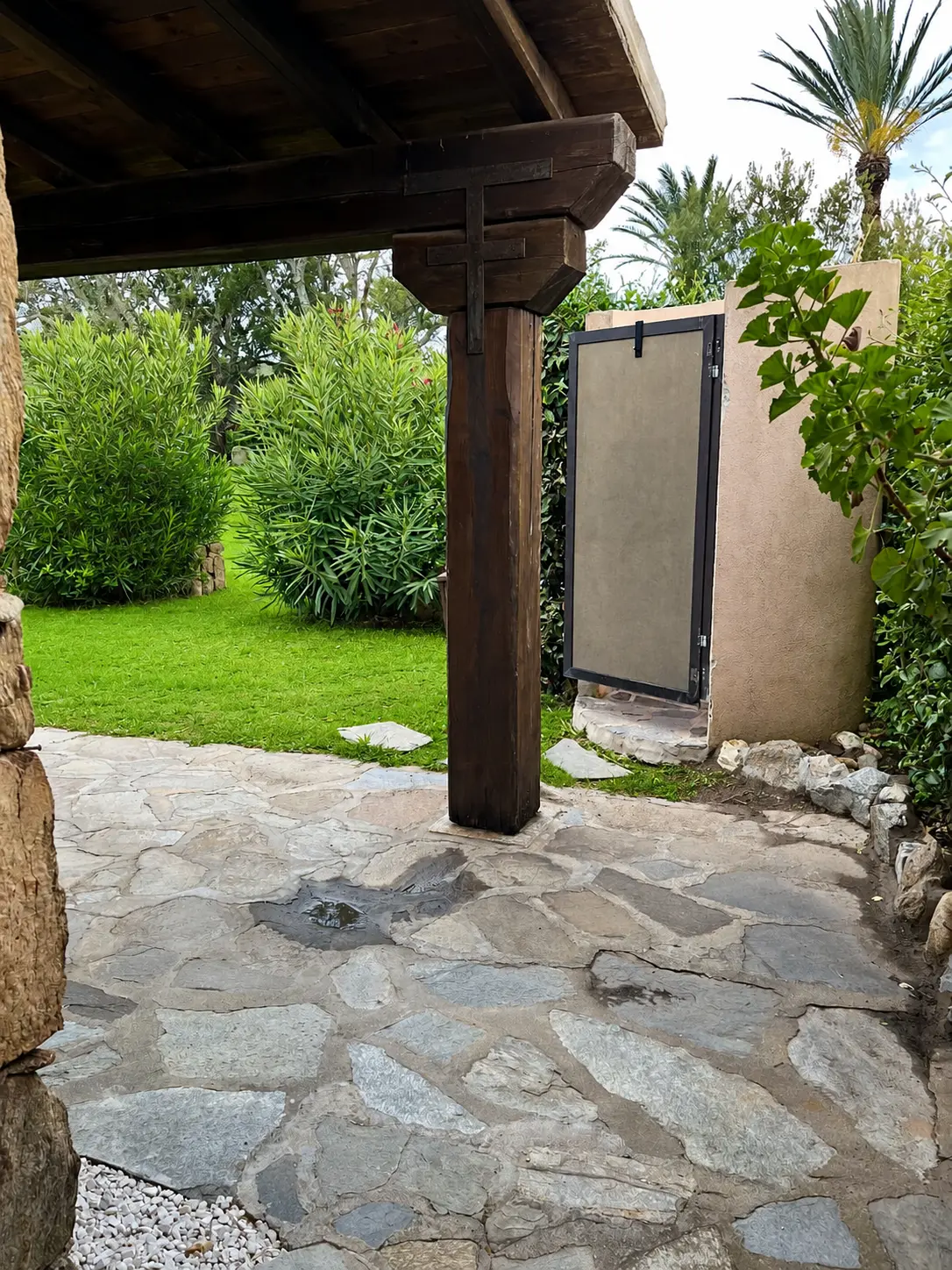 Private outdoor shower beside the garden and timber pergola